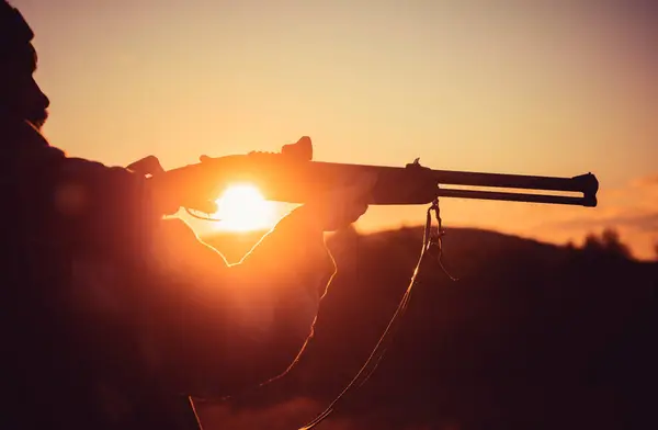 stock image Trigger of the shotgun. Rifle Hunter Silhouetted in Beautiful Sunset. Silhouette of the hunter