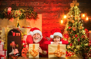 Santa helper with a huge bag. Family holiday. Little Santa huge bag run to delivery christmas gift. Santa Claus helper father and son with big box gifts clipart