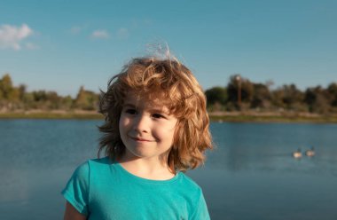 Funny child outdoor face close up. Kids head portrait