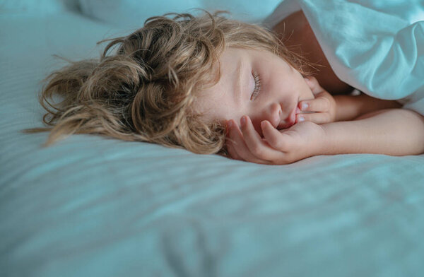 Kids on sleeping bed, happy bedtime in white bedroom. Kid sleep in bed