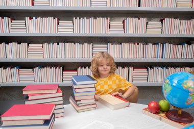 School and students in classroom. Education kids. Child pupil student in the school class. Studying and learning concept. School boy in the library near school supplies. Kid learn geography with globe