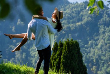 Doğada yaz tatili. Çiftler doğada eğlencenin tadını çıkarırdı. Açık havada aşık olan şehvetli bir çift. Kaygısız çift doğada sarıldılar. Onu tek koluyla destekliyor ve elini tutuyor.