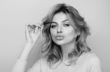 Woman comb eyebrows with eyebrow brush. Care for brows, eyebrows lamination. Brow beauty procedures. Beautiful woman with long eyelashes, eyebrows