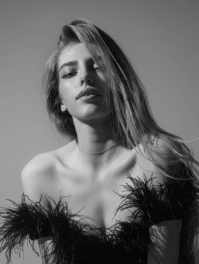 Beauty face of young blonde woman. Sexy model posing in studio. Portrait of beautiful girl. Beauty woman face closeup. Pretty girl face on studio background. Sensual look. Beautiful female face