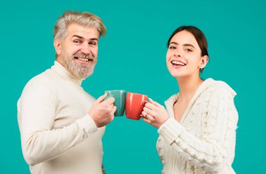 Friends drinking coffee or tea on blue background. Couple drinking tea. Morning cup, coffee mug, people on isolated background with copy space