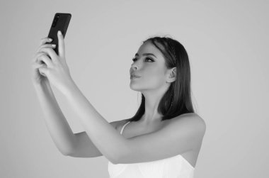 Young woman with phone, isolated on balcony terrace. Business woman using smartphone. Business talk. Girl using phone, chatting online. Young woman using mobile phone. Application for mobile phone