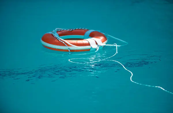 stock image Life buoy in blue swimming pool. Lifebuoy pool ring float on blue water