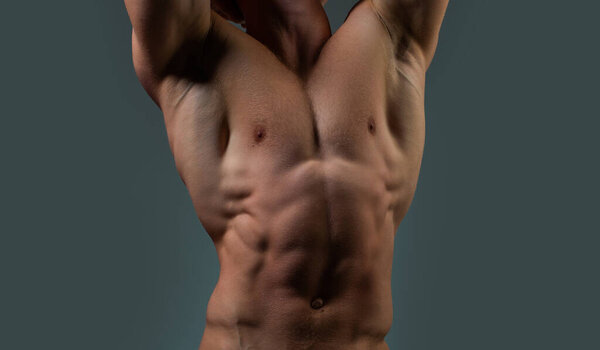 Six pack. Perfect abs, shoulders, and chest. Close up The Abs. Closeup torso. Ab. Muscular torso and ripped abs. Sexy male muscular body. Man with naked torso showing six pack abs