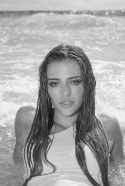 Outdoor lifestyle portrait of beautiful young woman on the beach. Natural beauty. Travel and youth. Summer vibes. Freedom and carefree concept. Sexy fashion woman playing on seashore