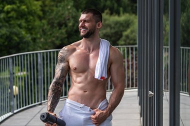 Fitness man in the gym. Young muscular man workout. Man with sexy strong body, strength and motivation. Fitness man at workout in gym pumping up muscles. Fitness and bodybuilding health