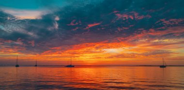 Denizin üzerinde gün doğumu ve güzel bulutlar. Renkli okyanus plajı gün batımı