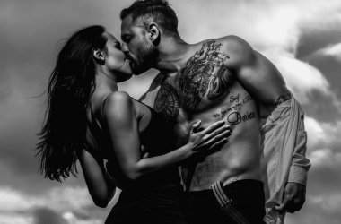 Naked shirtless muscular man and sexy woman. Loving people. Beauty woman gently undressing sexy body of sexy lover. Lovely couple in love. Sexy girl and fit muscular boyfriend with naked bare torso