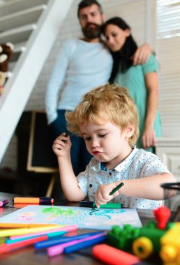 Mom and dad drawing with child. Happy family of three having fun together. Cheerful parents playing with son. Father mother and child playing together at home. Childhood learning, kids artistics