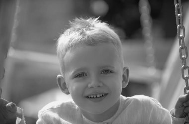 Dışarıdaki çocuğun portresi. Kapalı yüzlü çocuk yaz parkında dışarıda oynuyor.