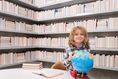 Back to school. School and students in classroom. Education kids. Studying and learning concept. School boy in the library near school supplies. Kid learn geography with globe