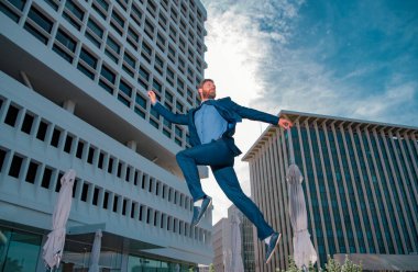 İş adamı koşuyor, zıplıyor. İş adamıyla hızlı iş yapma kavramı. Zirvede kalmak