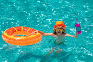 Young boy kid child splashing in swimming pool. Active healthy lifestyle, swim water sport activity on summer vacation with child. Summer kids cocktail