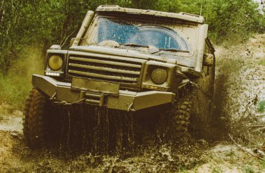 Mud and water splash in off-road racing. Offroad vehicle coming out of a mud hole hazard. Drag racing car burns rubber. Extreme. Off-road car. Rally racing clipart