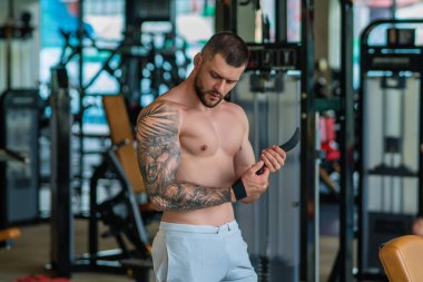 Portrait of handsome sporty man with muscular body doing weight lifting. Guy workout at gym. Fitness trainer, sport instructor, sporty man, fit model, sportsman workout. Power athletic guy bodybuilder