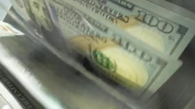 Macro, dolarları sayarak saymaya başladı. 100 dolarlık banknotları olan para sayma makinesi. Banka para birimi ve finans. Nakit para sayımını kapat. Kriz işleri, enflasyon kavramı