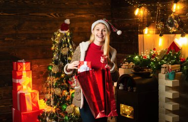 Girl enjoy cozy warm atmosphere christmas eve. Christmas joy. Woman wooden interior christmas decorations garland lights. Christmas tree. Pleasant moments. Filled with happiness cheer and love.