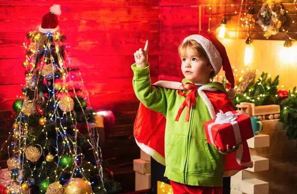 Noel 'de aileniz için en iyi dileklerimle. Mutlu Noeller ve mutlu yıllar. Sevimli küçük çocuk noel ağacının yanında oynuyor. Çocuk kış tatilinin tadını çıkarıyor. Evim neşe ve sevgiyle dolu.