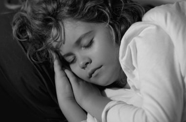 Kid sleeps face close up. Child boy take nap. Kid sleeping in bed. Comfortable mattress on bedroom. Soft pillow, comfy, cozy comfortable bed concept. Healthy kids sleeping