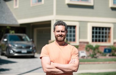 Evin önünde duran mutlu adam. Kendinden emin iş adamı.