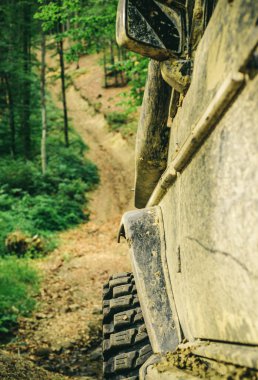 Alt görünümü büyük offroad araba tekerlek ülke road ve dağlar zemin üzerinde. Offroad araç bir çamur delik tehlikesi dışarı geliyor. Off-road aracı dağda gider