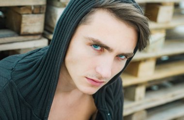 Genç adamın kameraya baktığı bir stüdyo fotoğrafı. Kendine güveni olan yakışıklı bir adam. Ciddi konsantre erkek modeli.