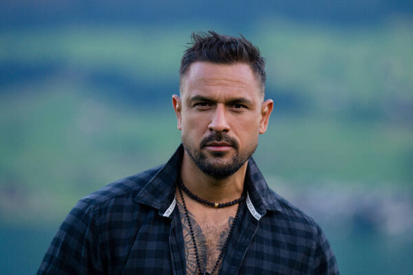 Portrait of the serious handsome man. A Hipster guy model headshot. Male serious face. Handsome serious man. Confident serious male model. Man looking proud. Closeup face of man outdoor. Elegant guy