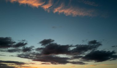 Gün batımı ya da gün doğumu. Dramatik görkemli gün batımı. Gökyüzü bulutlu ve gökyüzü aydınlık arka planda. Farklı şekillerde bulutlarla gün doğumu. Sakin gün batımı gökyüzü ve bulutlar arasında güneş