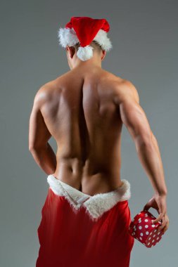 Seksi Noel Baba. Noel Baba şapkalı geylerin arkası. Yeni yıl şeritleri ve yetişkinler için hediyeler. Noel 'de kas geyliği. Kaslı vücutlu Noel Baba gay. Noel partisi. Yakışıklı seksi noel baba gay kulübü afişi için