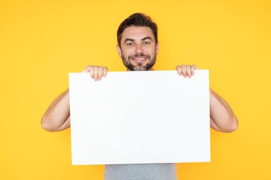 Boş tabela, reklam panosu ya da fotokopi alanı olan pano. Mutlu, yakışıklı, gülümseyen orta yaşlı adam stüdyo arka planında reklam panosu gösteriyor. Reklam konsepti. Boş model.
