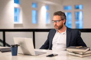 Office worker with laptop at office. Ofice employee remote working in modern office. Businessman have on line meeting. Business man using computer in office. Modern offices workplace