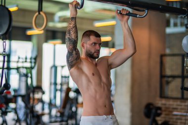 Muscular athletic fit man hard workout fitness in gym. Sport fitness and bodybuilding. Strong muscular doing exercise in the gym. Sexy muscular male body. Fitness man in the gym. Fitness training