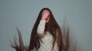 Saç stili, saç bakım konsepti. Çok uzun saçlı güzel kız. Uzun saçlı kadın uzun saçlarını sallıyor. Uçan Saçlı Kız. Saç stili olan güzel bir mankenin portresi. Rüzgarda uçuşan saçlar