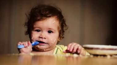 Bebek kaşıkla yiyor. Çocuk yemeğini ye. Çocuk maması yiyen aç küçük bir çocuk. Bebek yulaf lapası. Küçük bebek sağlıklı yiyecekler yiyor. Küçük bir bebek yemeğini yiyor. Komik çocuklar yüz ifadeleri