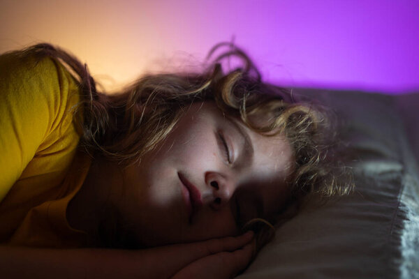Child sleeping in a bed. Cute kid sleep. Kids pillow and blanket for sleeping. Little boy sleeps. Adorable kid sleeps in bed. Sleeping child. Kid sleeping in dark bedroom