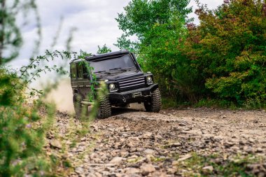 Tires in preparation for race. Mudding is off-roading through an area of wet mud or clay. Travel concept with big 4x4 car. Off-road vehicle goes on the mountain. Jeep outdoors adventures. Safari suv clipart