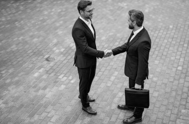 Businessman shaking hands. Two businessmen handshake outdoor. Handshake business people. Handshake of two business man in suit top view. Business team business strategy clipart