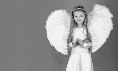 Melek çocuk afişi, izole edilmiş stüdyo geçmişi. Beyaz elbiseli şirin bir kız çocuğu, renkli arka planda dikiliyor. Güzel kanatları olan bir çocuk melek. Mutlu küçük melek