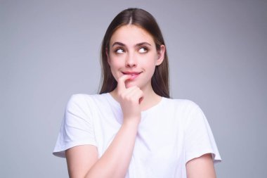 Surprised shocked young girl isolated over gray studio background. Close up shot of emotive shocked young woman opens mouth widely, Wow, unbelievable. People expressive emotions clipart