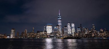 New York gece gökdelenleri. Gün batımında Manhattan. Işıklı New York manzarası. New York 'ta bir gece. NYC gece manzarası. Manhattan şehir merkezi. Alacakaranlıkta New York. Amerikan şehri. New York şehrinin silüeti