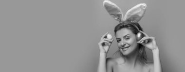 Smiling bunny girl. Happy easter. Pinup style isolated on pink banner, copy space. Panoramic web banner frame