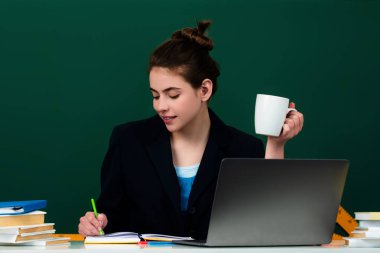 Lise sınıfındaki öğrenci kız. Lisedeki bilgi. Lisedeki ya da üniversitedeki liseli kız. Öğrenci sınıfta kahve içiyor. Üniversitede kahve molası. Öğrenci kız kahve fincanı tutuyor.