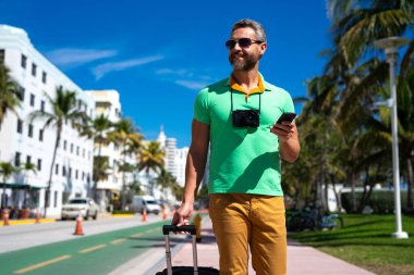 Yalnız seyahat etmek. O, şehirde seyahat etmeye başlarken, o yaz tropikal caddede bir turist. Yaz gezisi. Seyahat seyahati. Yaz, seyahat için mükemmel bir zamandır. Seyahat eden insanlar