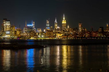 Geceleri New York 'ta. Gökdelenleri olan New York şehri. New York 'un alacakaranlıkta gökyüzü panoramik. Manhattan silueti. New York ve Hudson Nehri. New York şehir merkezi. Günbatımında New York gökdelenleri