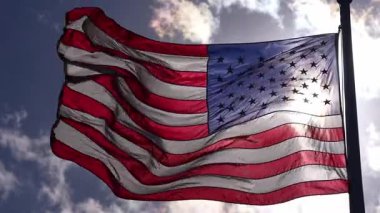 Mavi gökyüzünde dalgalanan Amerikan bayrağı. Birleşik Devletler bayrağı. Rüzgarda bayrak. Amerika 'nın vatansever bayrakları. ABD ulusal sembolü. Özgürlük ve demokrasi. Bağımsızlık Günü. Yıldızlar ve çizgiler. ABD bayrağı sallıyor