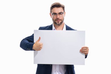 Man holds the white sign, blank card. Placard ready for your product. Sign to your text. Man showing thumbs up and blank sign board over studio background. Empty blank board. Area for advertising